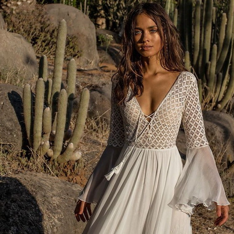 Elevate your wedding look to new levels of adventure with the Robe Esmira. This elegant lace boho style dress exudes confidence and dares you to take risks. Glide down the aisle and create a lasting impression with this bold and inspiring wedding dress.