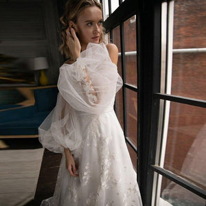 Unleash your inner goddess with our Robe Dahlia. This exquisite white dress features intricate bridal floral embroidery, creating a chic and romantic look. Perfect for any special occasion, this dress will make you feel like a true work of art. Elevate your wardrobe with this exclusive piece.