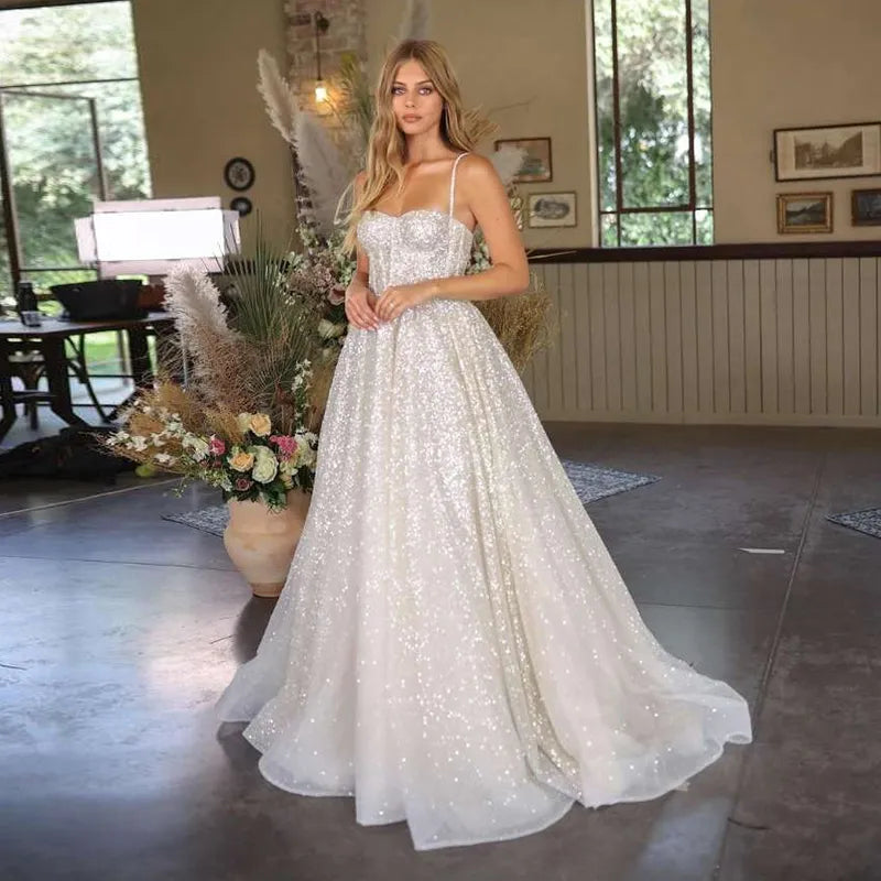 Unleash your inner risk-taker with the Robe Elestren! This dazzling Boho-style wedding dress features spaghetti straps, shimmering sequins, and a princess silhouette for a truly show-stopping look. Perfect for the adventurous bride who wants to make a bold statement on her special day.