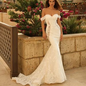 Indulge in luxury with our Robe Felicienne, a deluxe mermaid-style wedding robe featuring exquisite detachable off-the-shoulder sleeves. Say "I do" in style with this sophisticated and exclusive piece, designed to make you feel like the most elegant bride on your special day.