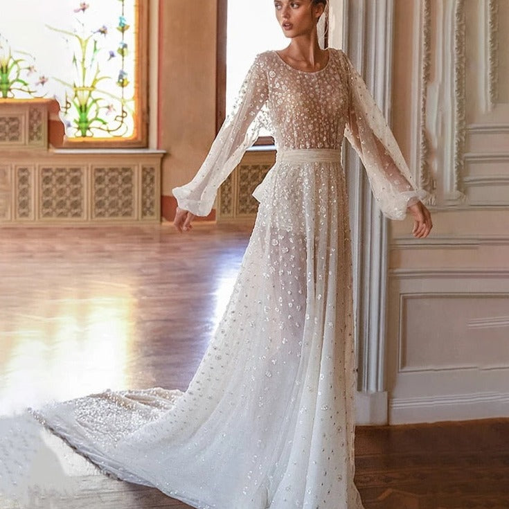 Introducing the elegant Robe Saffron, a custom floor-length A-line bridal gown with long sleeves and a round neckline. Designed for a perfect fit and a sophisticated look, this stunning robe is the perfect choice for any bride. Make a statement and feel confident on your special day with Robe Saffron.