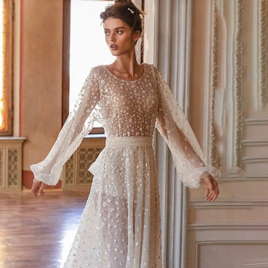 Introducing the elegant Robe Saffron, a custom floor-length A-line bridal gown with long sleeves and a round neckline. Designed for a perfect fit and a sophisticated look, this stunning robe is the perfect choice for any bride. Make a statement and feel confident on your special day with Robe Saffron.