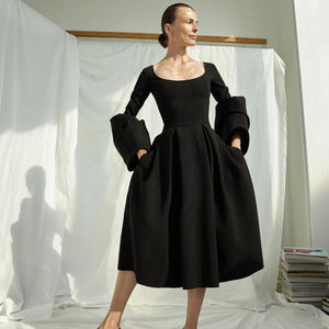 Architectural shapes and inherent femininity are two hallmarks of the A.W.A.K.E. Mode brand. Producing pieces that feel defined and structured yet still manage to be elegant and ethereal, the labeloffers a masterclass in modern dressing. This dress feels evidential of that, combining a figure-hugging top with a full skirt and vibrant, puffed sleeves.