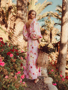 Introducing Robe Fannia, a stunning floral printed long dress for women. With its elegant long sleeves and open back, this dress is perfect for summer parties and beach vacations. The vibrant pink color and lace-up neckline add a touch of femininity to the stylish design. Upgrade your wardrobe with this must-have piece.