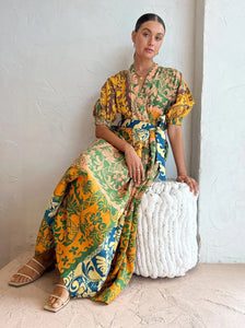 A tropical delight, ALÈMAIS welcomes the Archie Wrap Dress in Multi.   Crafted from a linen fabrication, this relaxed wrap dress silhouette features tuck details at the waist, elasticated cuff and self tie.   Falling to a flared skirt, it is the perfect companion for long lunches, beach days and weekend wanderings.