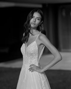 Indulge in luxury and grace with our Robe Masha. This elegant A-line bridal gown exudes sophistication and chic style. The intricate design and tasteful craftsmanship make it the perfect choice for your special day. Elevate your bridal look and feel like a true VIP in our exclusive gown.