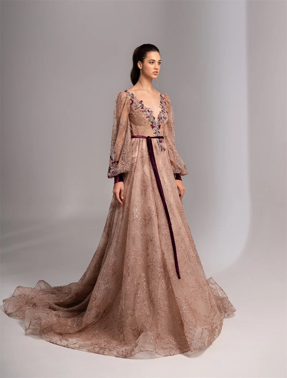 Elevate your formalwear game with our Dress Octavia. The charming flesh-pink color, long sleeves, V-neckline, and stunning A-line silhouette create a timeless and elegant look. With a custom-made fit and sweep train, this dress will make you feel like a true prom queen. Available in various sizes.