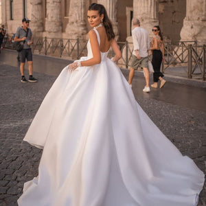 Indulge in the luxurious and exclusive Robe Lola. Crafted with a satin fabric, this gown features a chic A-line design fit for any princess bride. Elevate your bridal experience with this sophisticated and elegant piece.