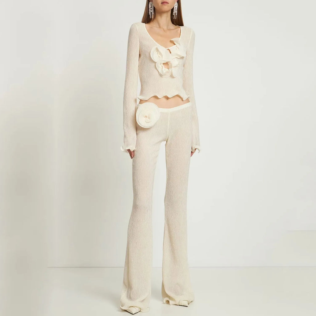 Elevate your wardrobe with the Ensemble Alice Shirred Knit Flower by Magda Butrym. Adorned with wooden ear trim and delicate three-dimensional flowers, this long-sleeved shirt and blouse set exudes a sense of sophistication and elegance. The lightweight, knitted fabric adds a touch of luxury to your everyday style.