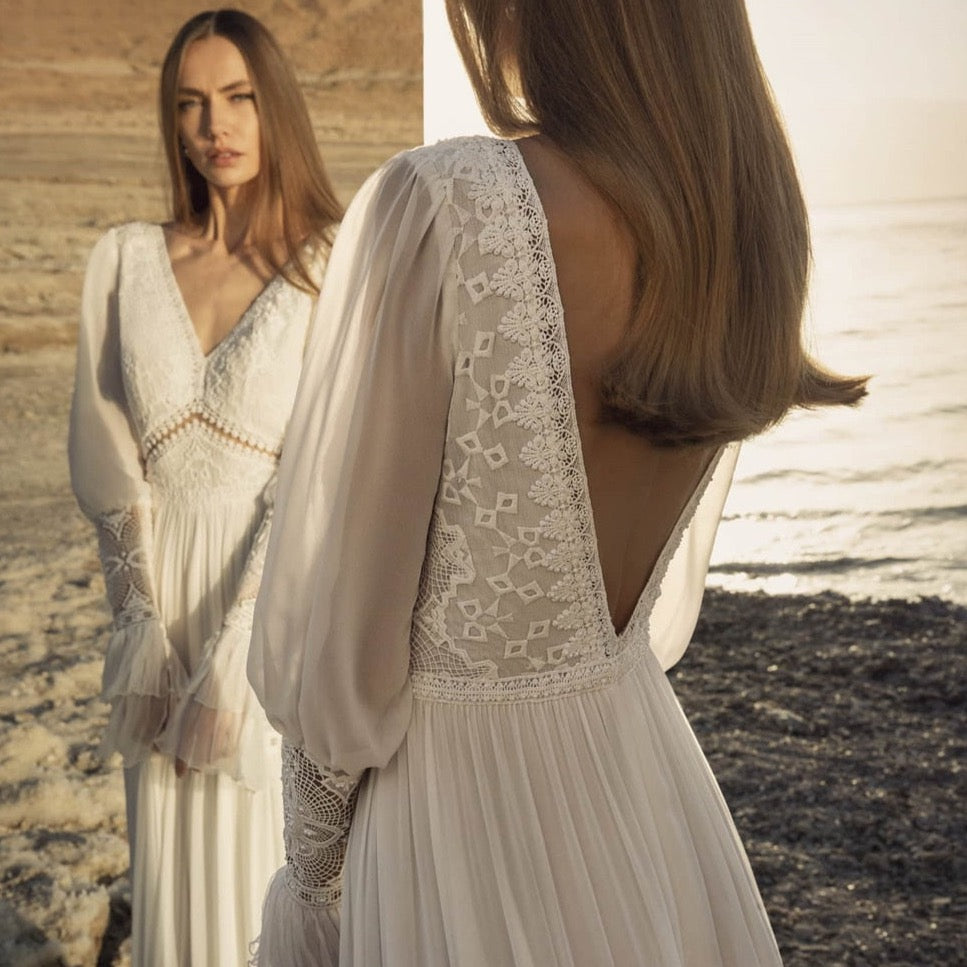 Introducing the Robe Rowane: a dreamy, elegant lace wedding gown that will make any bride feel like a boho princess. With delicate embroidery and long sleeves, this gown is both stylish and timeless. Perfect for a romantic and whimsical wedding, it will surely make all of your bridal dreams come true.