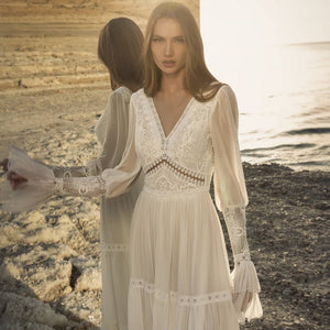 Introducing the Robe Rowane: a dreamy, elegant lace wedding gown that will make any bride feel like a boho princess. With delicate embroidery and long sleeves, this gown is both stylish and timeless. Perfect for a romantic and whimsical wedding, it will surely make all of your bridal dreams come true.