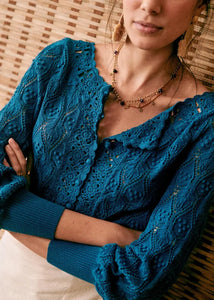 Elevate your look with Cardigan Anika. Crafted from 100% cotton, this brand women's sweater boasts a delicate hollow out crochet design, perfect for spring and summer. With a large O neck and solid color, this knitted cardigan exudes elegance and refinement. A must-have for any fashion-forward wardrobe.