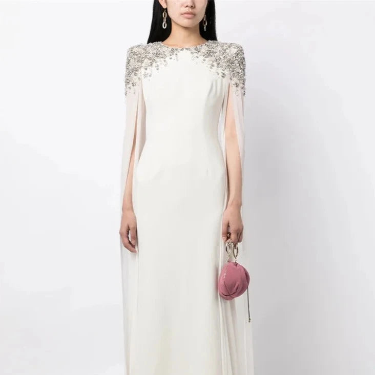 Unleash your inner glamour with Dress Jenna by Jenny Packham. This stunning evening dress exudes elegance and sophistication, making you the center of attention at any special occasion. With delicate details and a flattering silhouette, it's the perfect addition to your wardrobe. Make a statement with Dress Jenna!