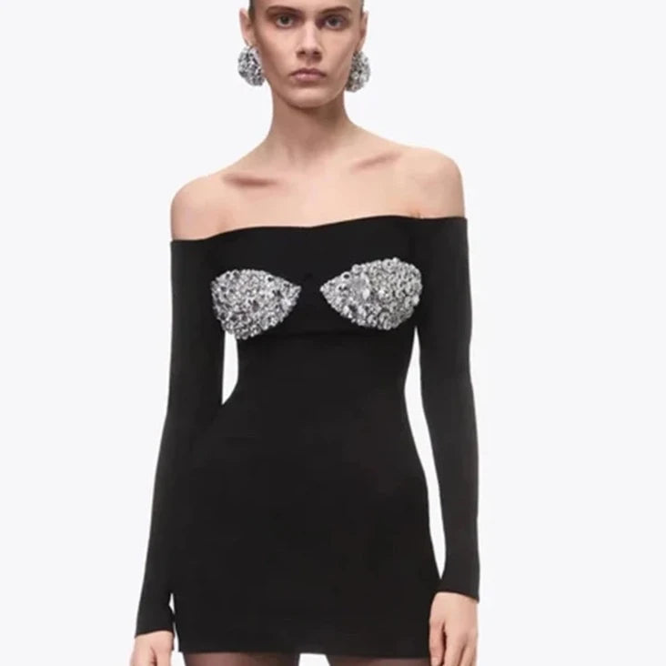 This elegant minidress features a sexy off shoulder design and sparkling crystal embellishments. The diamond bandage construction offers a figure-flattering fit, while the beaded details add a touch of glamour. Perfect for a special occasion, this dress is both stylish and alluring.