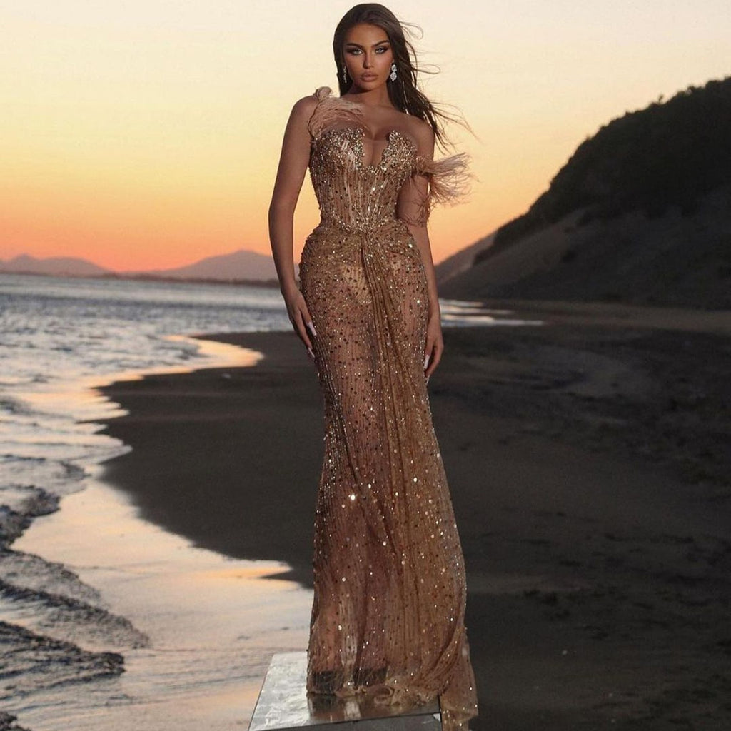 Introducing the captivating Robe Faye. Handcrafted from a shimmering golden weave for a glorious and luminous finish, this luxurious gown is sure to turn heads with its sparkling mermaid silhouette and intricate detailing. Make a statement in incomparable style and undeniable glamour.