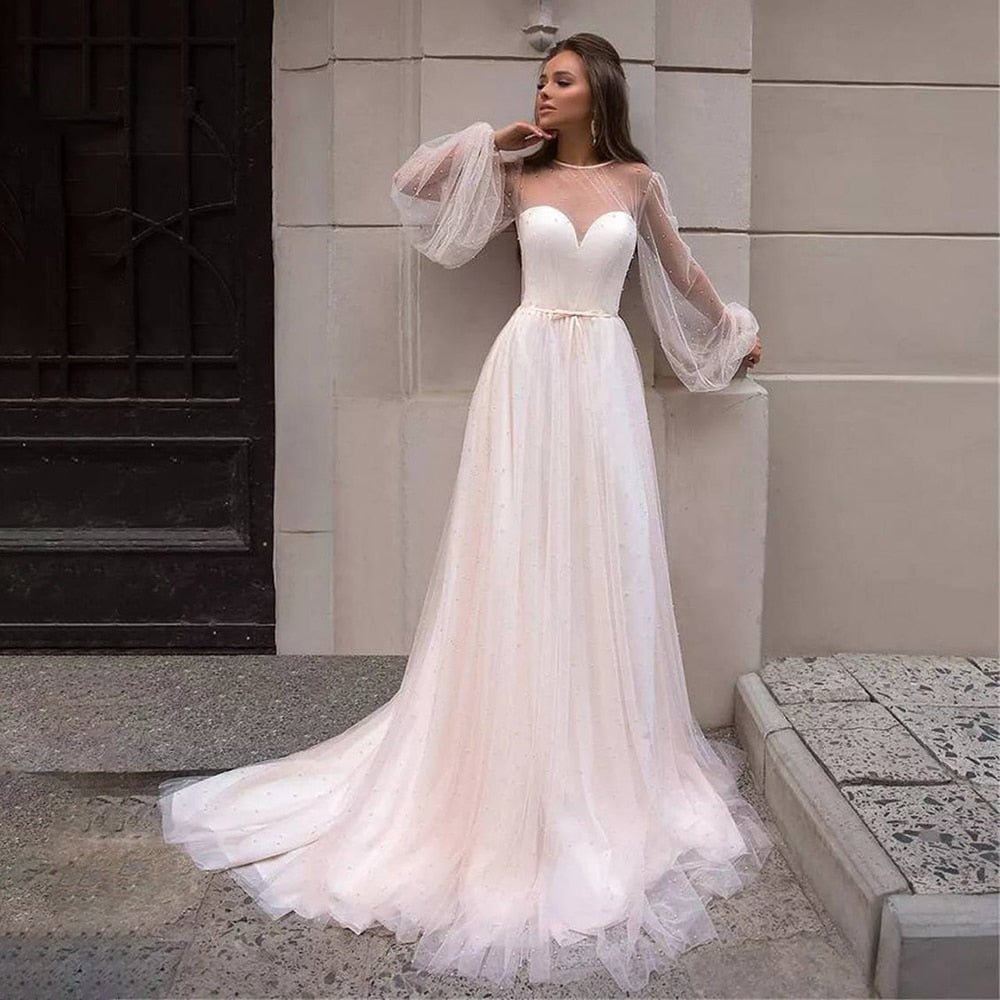 As a bridal industry expert, I introduce the elegant Robe Lumi, an A-line bridal gown designed to enhance your natural figure. Its timeless silhouette will provide a sophisticated yet romantic look for your special day. Experience the perfect blend of modern elegance and traditional beauty with Robe Lumi.