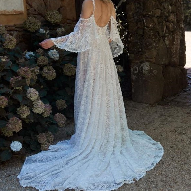 "Be the boho mermaid bride of your dreams in the Robe Malibu. This lace gown will make you feel like you're floating on the waves as you say "I do". With a touch of whimsy and a hint of romance, this dress is perfect for the free-spirited bride."