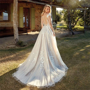 Be the center of attention with the elegant and stylish Robe Kerensa. This V-neck wedding dress is perfect for the fashion-forward bride, complete with cap sleeves and intricate lace appliques. Make a statement on your special day with the stunning Robe Kerensa.