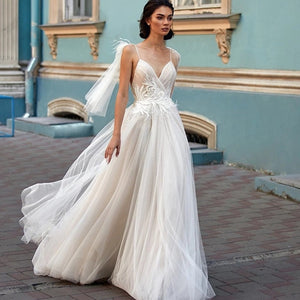 "Get ready to walk down the aisle in style with the Robe Sigrid. This elegant, bohemian wedding dress features delicate spaghetti straps and intricate appliques, making it the perfect choice for any bride looking to add a touch of whimsy to their big day. Say "I do" to this unique and stunning dress. (and to your significant other too!)"