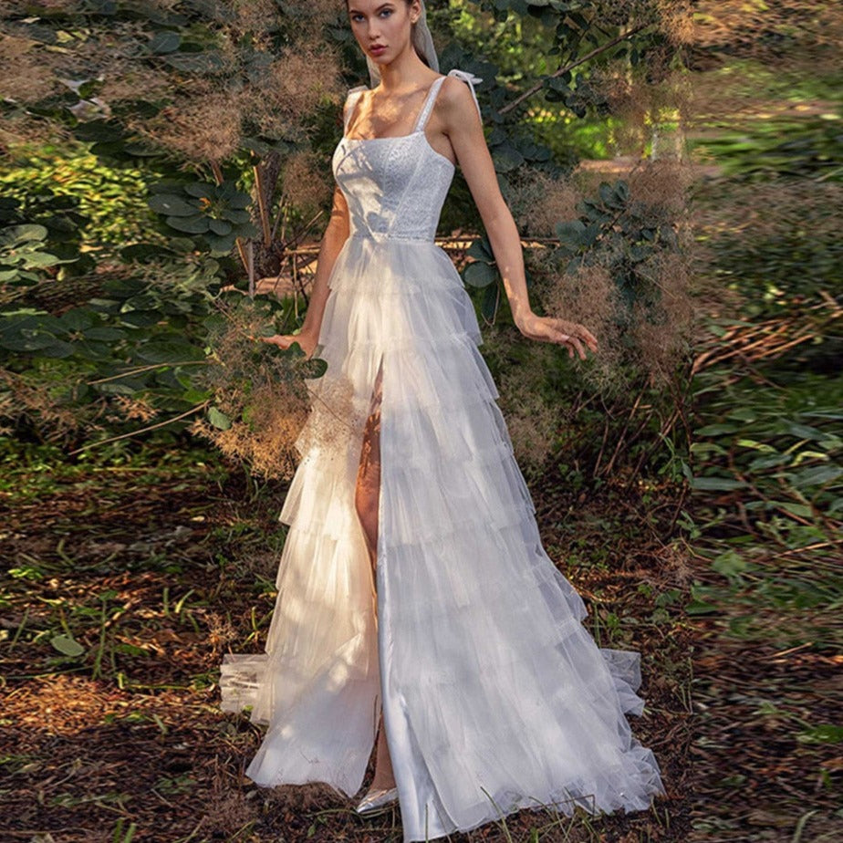 Indulge in pure luxury with our elegant Robe Fena. This sexy bohemian wedding dress features delicate tiered straps and a stunning open back. Its A-line silhouette will flatter your figure while allowing you to move gracefully on your special day. Say "I do" in style with Robe Fena.