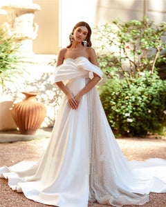 Introducing the Robe Saverine, a stunning a-line wedding gown handcrafted with exquisite French satin. Elevate your special day with this elegant and luxurious dress, designed to make you feel like a work of art walking down the aisle. Embrace the beauty of simplicity and sophistication with this one-of-a-kind piece.