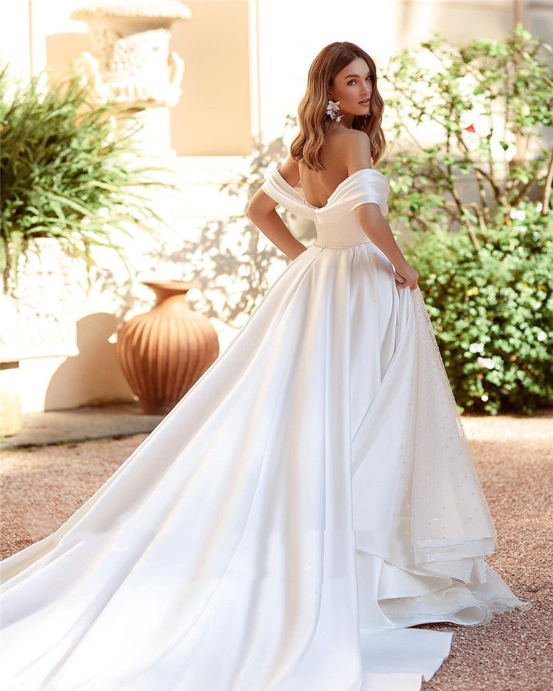 Introducing the Robe Saverine, a stunning a-line wedding gown handcrafted with exquisite French satin. Elevate your special day with this elegant and luxurious dress, designed to make you feel like a work of art walking down the aisle. Embrace the beauty of simplicity and sophistication with this one-of-a-kind piece.