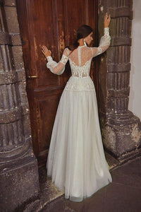 This elegant A-line wedding dress, the Robe Natalie, features intricate embroidery that adds a touch of sophistication to your special day. The A-line silhouette offers a flattering fit for all body types, while the delicate details create a timeless and elegant look. Make a statement on your wedding day with this beautifully designed dress.