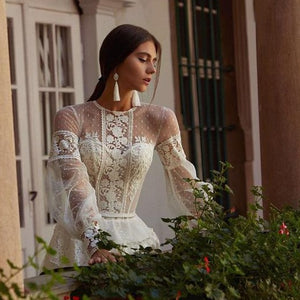 This elegant A-line wedding dress, the Robe Natalie, features intricate embroidery that adds a touch of sophistication to your special day. The A-line silhouette offers a flattering fit for all body types, while the delicate details create a timeless and elegant look. Make a statement on your wedding day with this beautifully designed dress.